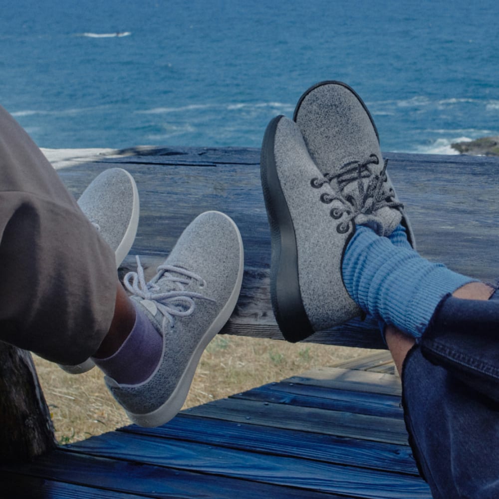 Two People Wearing Allbirds Shoes and Sitting on the Shore of the Sea!